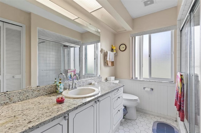 bathroom featuring tile patterned floors, walk in shower, vanity, wooden walls, and toilet