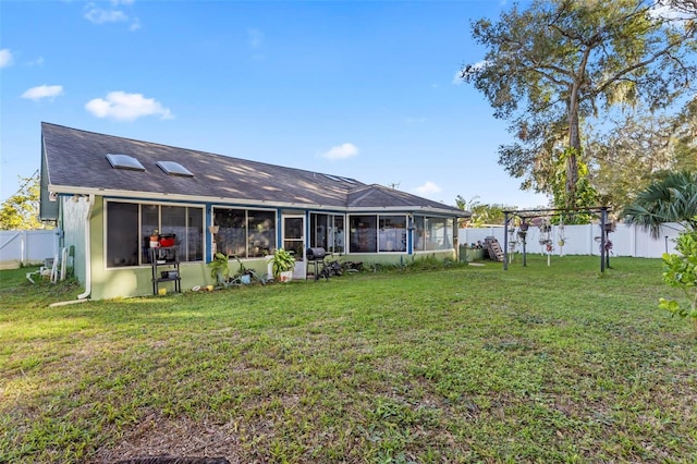 50 Florida Park Dr, Palm Coast, FL 32137 - rear view of house with a sunroom, a fenced backyard, and a shingled roof