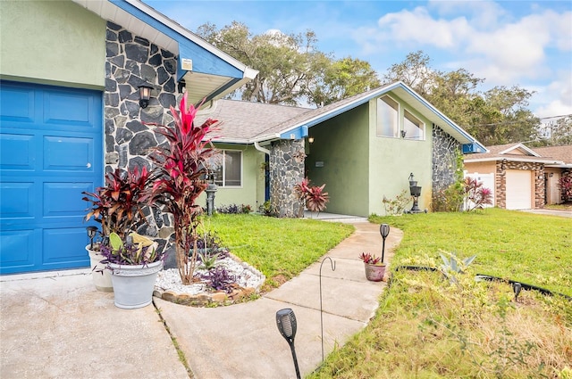 view of front of property with a front yard and a garage