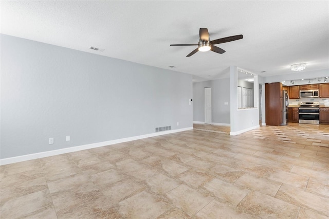 unfurnished living room featuring a textured ceiling and ceiling fan