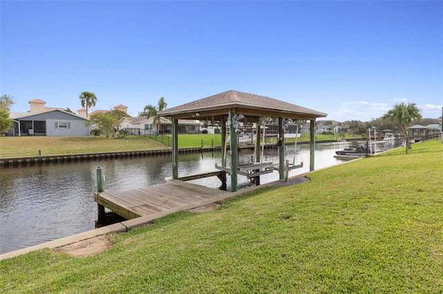 view of dock featuring a lawn and a water view