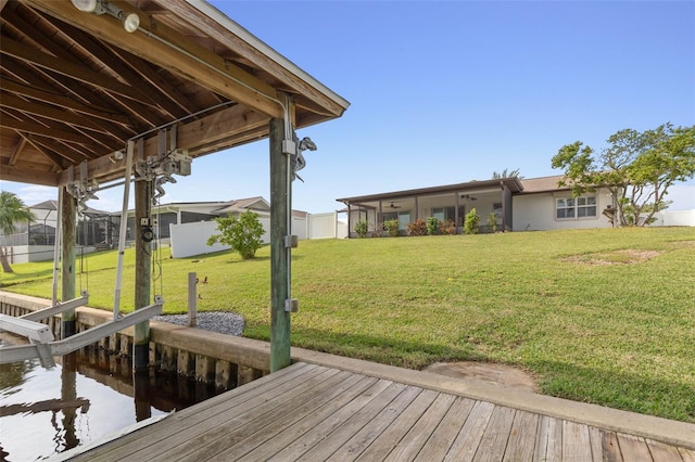 view of dock with a lawn