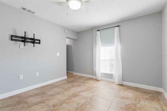 spare room featuring ceiling fan and a textured ceiling