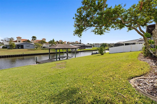 view of yard featuring a dock and a water view