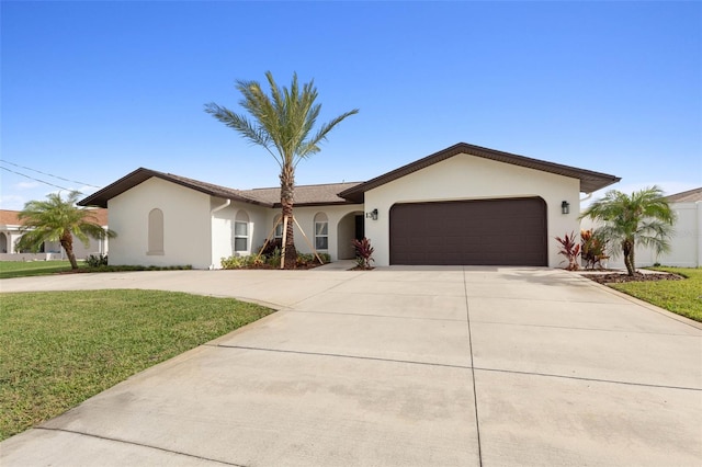 single story home featuring a garage and a front yard