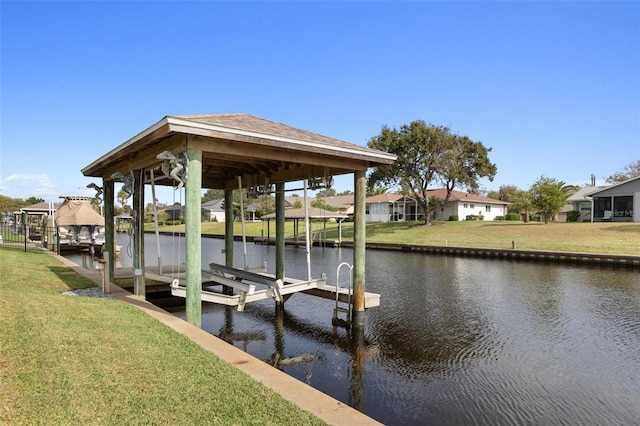 view of dock with a water view and a yard