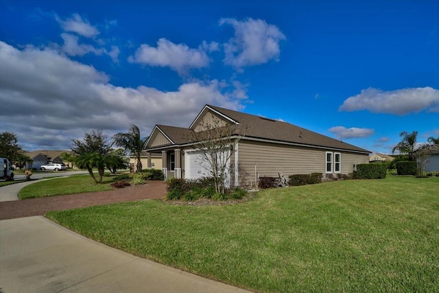 view of side of property with a garage and a yard