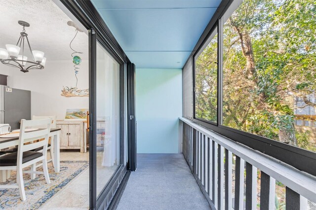 sunroom featuring a chandelier