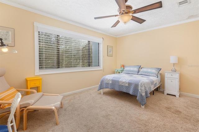 bedroom with carpet flooring, ceiling fan, a textured ceiling, and ornamental molding