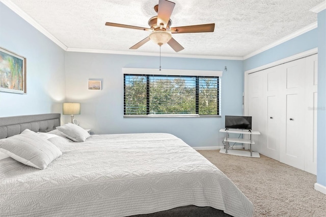 carpeted bedroom with a textured ceiling, a closet, ceiling fan, and crown molding