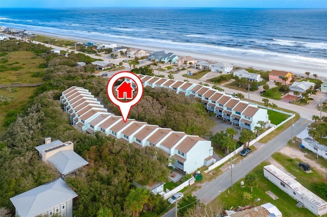 drone / aerial view featuring a water view and a beach view