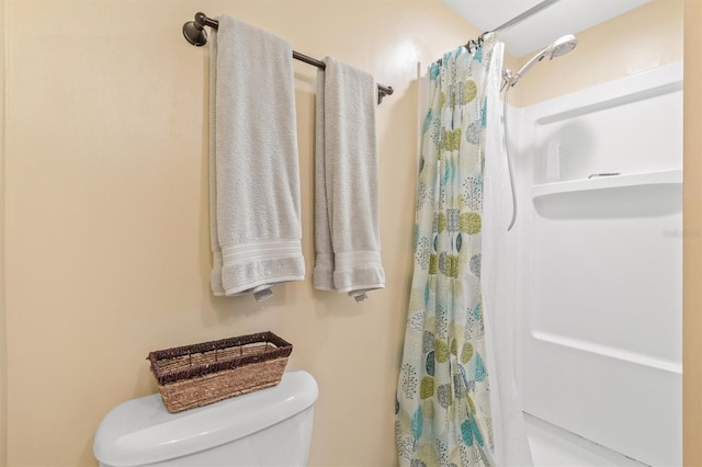 bathroom featuring toilet and walk in shower