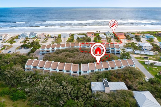 birds eye view of property with a water view and a view of the beach