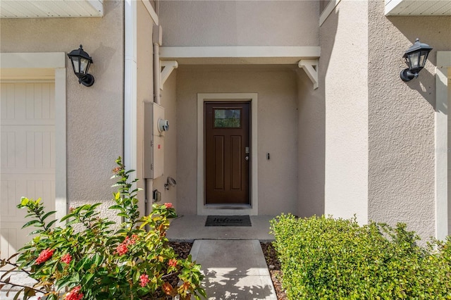 doorway to property with a garage