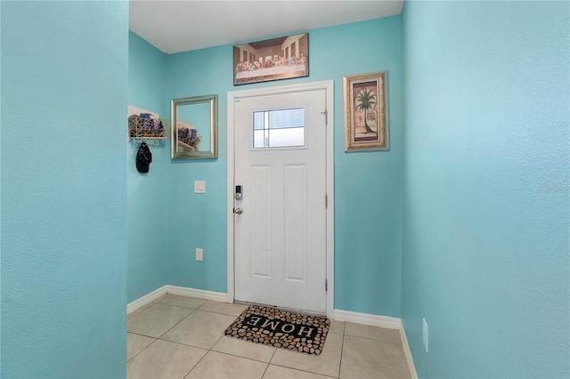 doorway to outside with light tile patterned flooring