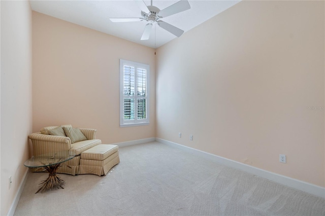 living area with ceiling fan and light carpet