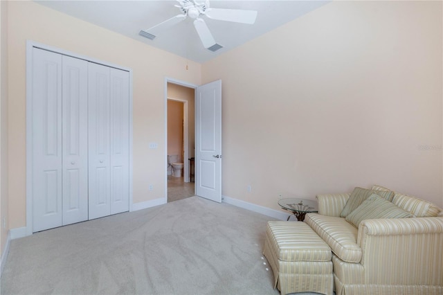 sitting room featuring ceiling fan and light colored carpet