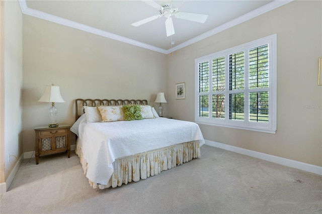 carpeted bedroom featuring ceiling fan and ornamental molding