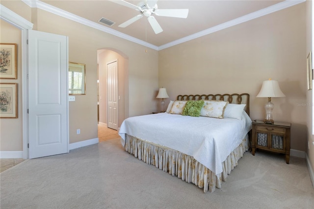 bedroom with ceiling fan, light colored carpet, and ornamental molding