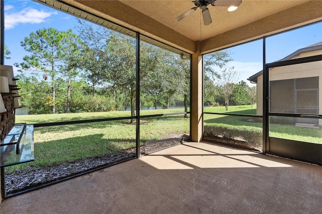 unfurnished sunroom with ceiling fan