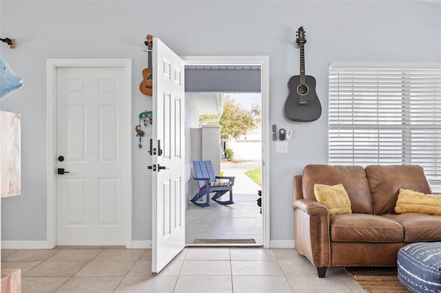 entryway with light tile patterned flooring