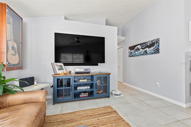 living room with vaulted ceiling and light tile patterned flooring