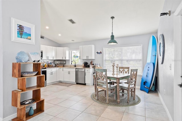 kitchen featuring lofted ceiling, dishwasher, hanging light fixtures, light tile patterned floors, and white cabinetry