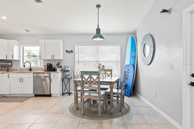 dining space with sink and light tile patterned floors