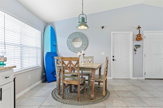 tiled dining area featuring lofted ceiling