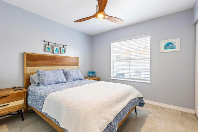 tiled bedroom featuring ceiling fan