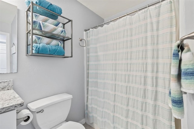 bathroom featuring vanity, toilet, and a shower with shower curtain