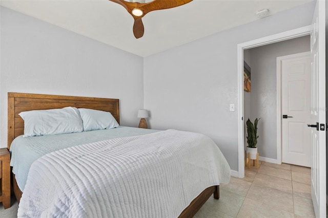 tiled bedroom featuring ceiling fan