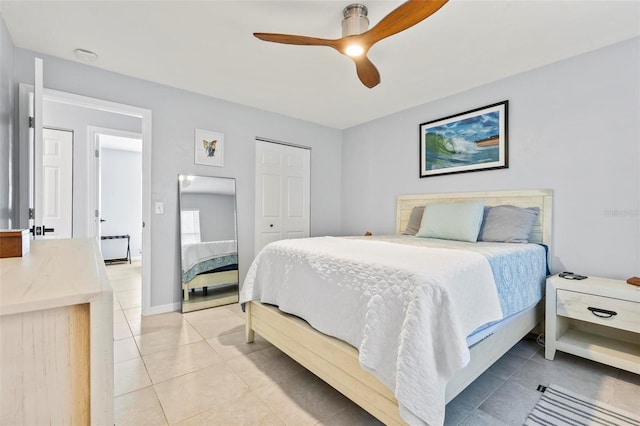 bedroom with light tile patterned floors, ceiling fan, and a closet