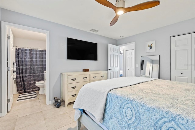 bedroom with ensuite bathroom, ceiling fan, and light tile patterned flooring