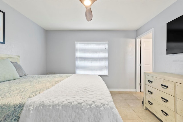 tiled bedroom featuring ceiling fan