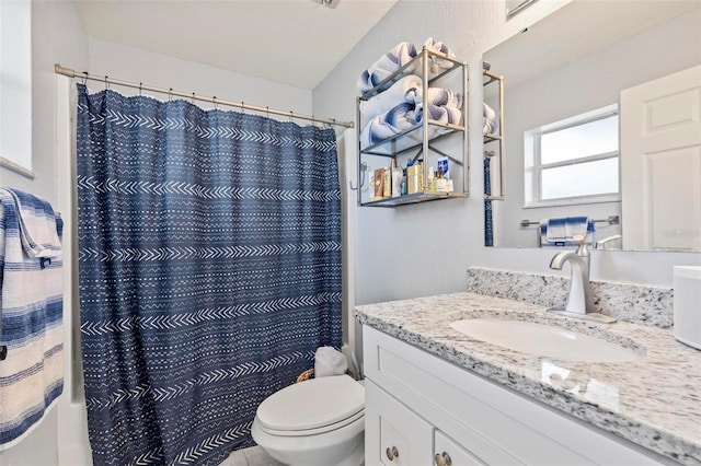 bathroom featuring vanity, toilet, and a shower with curtain