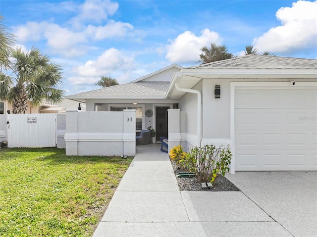 view of front of house with a garage and a front yard