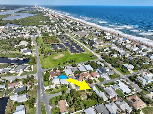 birds eye view of property featuring a beach view and a water view