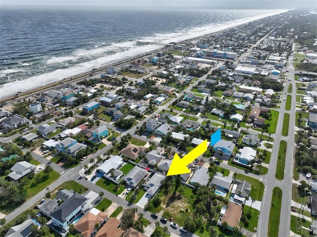 drone / aerial view with a beach view and a water view