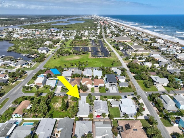 drone / aerial view with a water view and a beach view