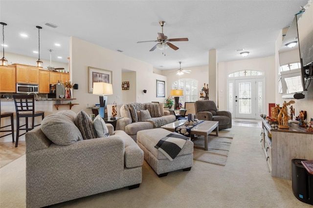 carpeted living room featuring ceiling fan