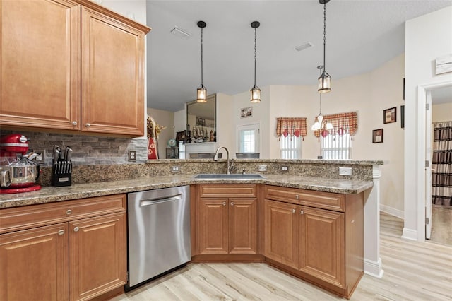 kitchen with dishwasher, light hardwood / wood-style flooring, sink, and stone countertops