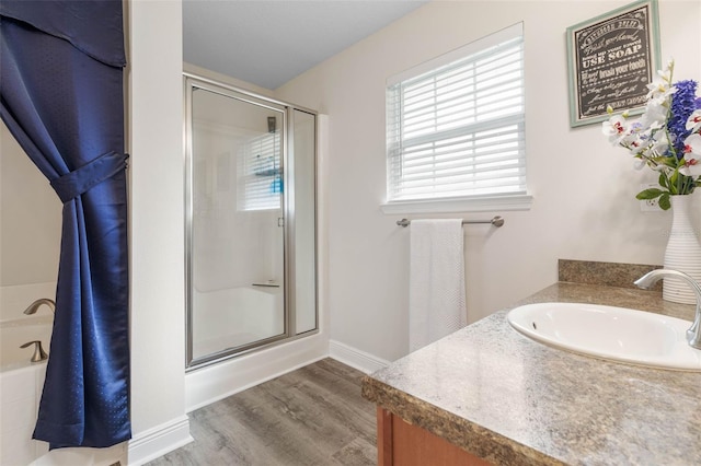 bathroom featuring walk in shower, vanity, and hardwood / wood-style flooring