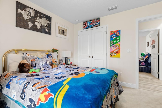 bedroom featuring light colored carpet and a closet