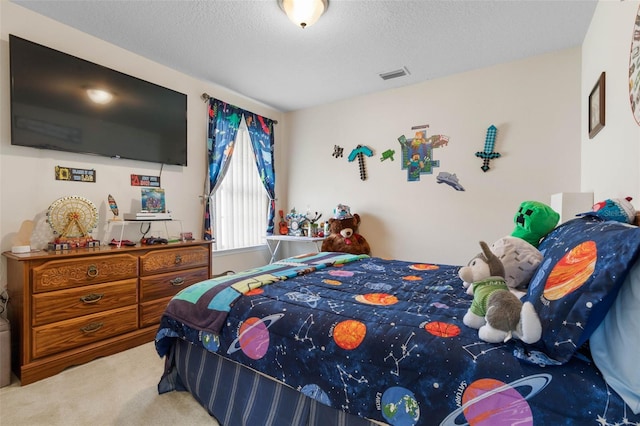 bedroom featuring a textured ceiling and carpet flooring