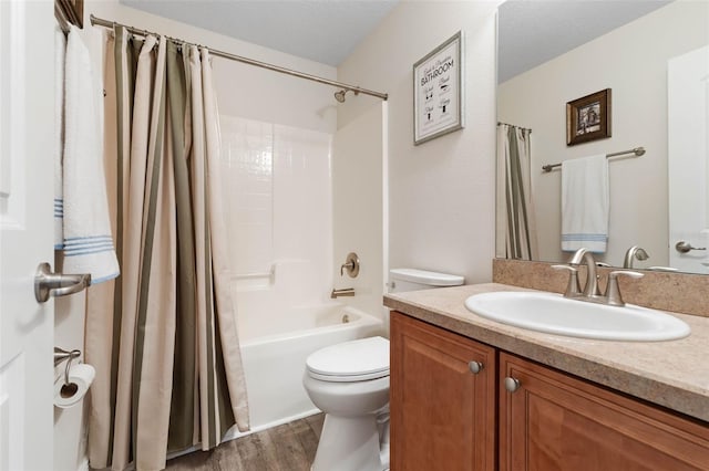 full bathroom with hardwood / wood-style floors, shower / tub combo with curtain, a textured ceiling, and vanity