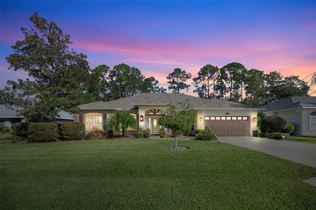 view of front of house with a lawn and a garage