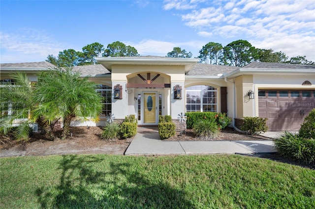 view of front facade with a garage and a front yard