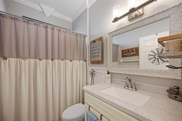 bathroom featuring ornamental molding, a wainscoted wall, vanity, and toilet