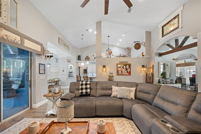 living area with recessed lighting, visible vents, light wood-style flooring, a ceiling fan, and high vaulted ceiling